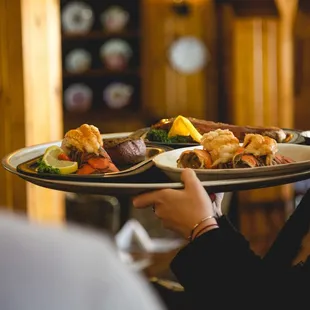 a woman holding a tray of food