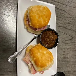 a ham and cheese sandwich with a side of mustard