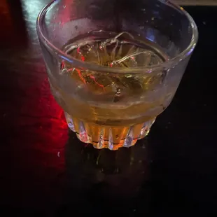 a glass of alcohol on a table