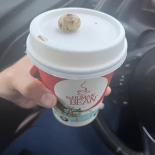 Small drink with white chocolate espresso bean on top