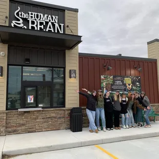 a group of people standing outside of a building