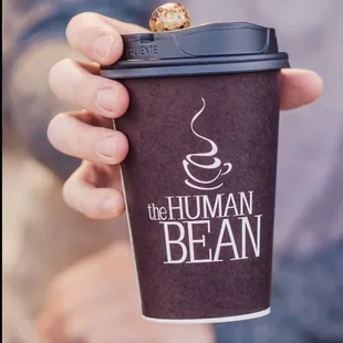 a person holding a cup of coffee