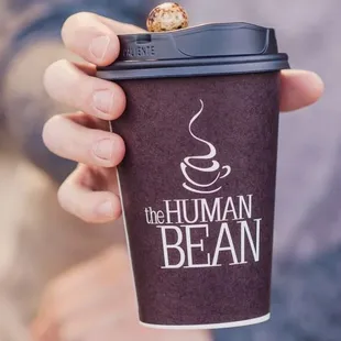 a person holding a cup of coffee
