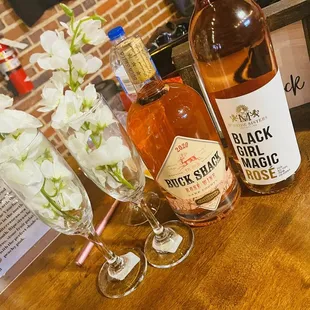 a bottle of blackbird magic and two glasses of wine