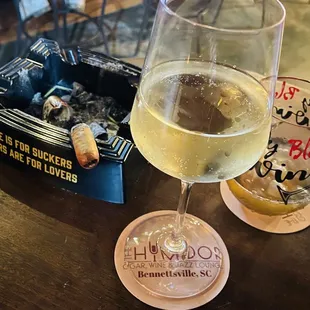 a glass of wine and a box of cigarettes