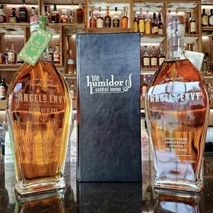 two bottles of whiskey on a bar