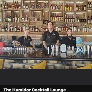 three men behind the bar