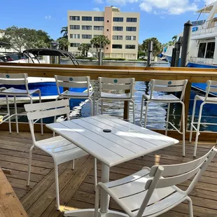 a table and chairs on a dock