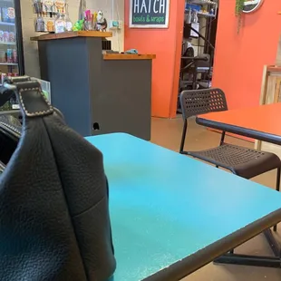a black purse on a blue table