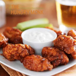 a plate of buffalo wings with ranch dip