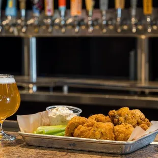 a tray of food and a glass of beer