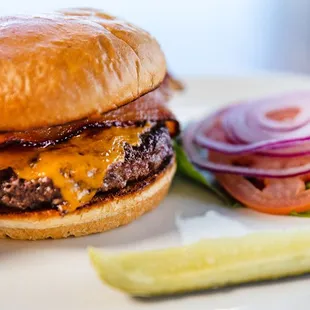a burger and pickle on a plate