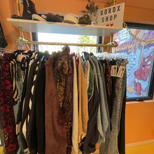 GordX shop consignor in the shop with a very curated rack of clothing and footwear