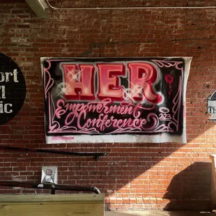 a sign on a brick wall