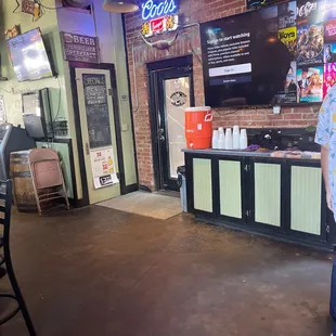 a man standing in front of a bar