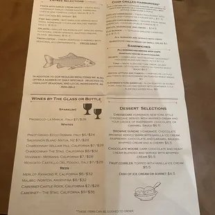 a menu and a glass of wine