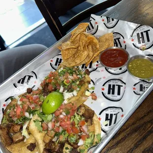 a tray of tacos and chips