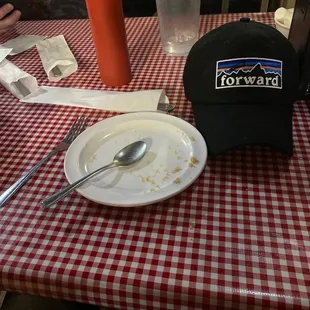 a plate of food and a hat on a table