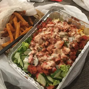 Chicken rice platter with a side of Fries