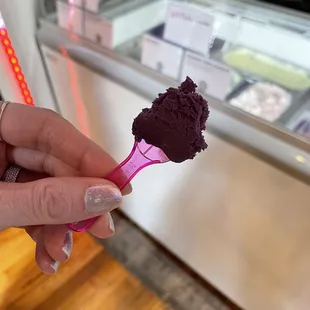 a hand holding a scoop of ice cream