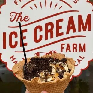 Salted caramel Oreo ice cream in a waffle bowl with crushed Oreos and caramel