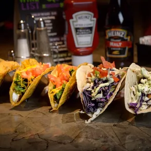 a row of tacos with coleslaw and coleslaw slaw