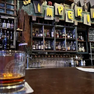 a glass of whiskey on the bar