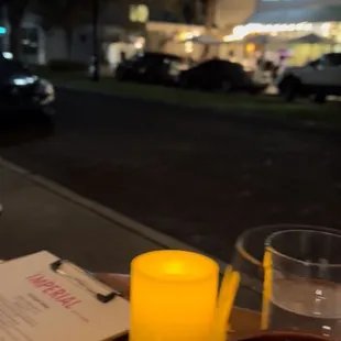 a glass of wine and a candle on a table