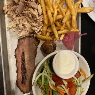 Beef brisket, pulled barbecue chicken, large salad and fries