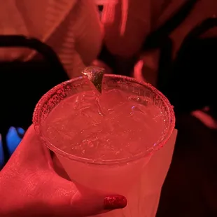 a person holding a drink in a plastic cup