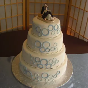 4 tiered wedding cake with lemon, apple spice cake, and red velvet cake