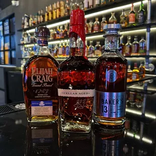 three bottles of alcohol on a bar