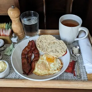 Country breakfast complete with eggs, smoked bacon, and an English muffin
