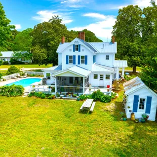 Back of our historic Chesapeake BnB main house with view of pool and crab shack that holds fishing gear, beach chairs, etc. for guests use