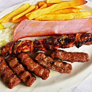 Cevapi with a skewer of kabob and a big chunk of ham.
