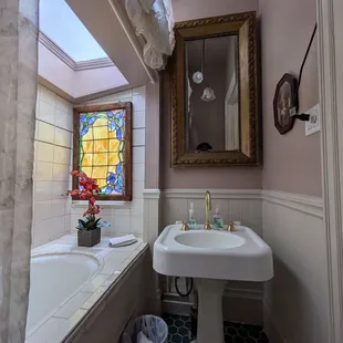 The bathroom in the reception area, past the check in nook under the stairs.