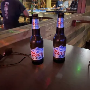 two bottles of beer on a table