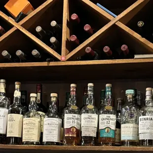 a shelf of liquor bottles