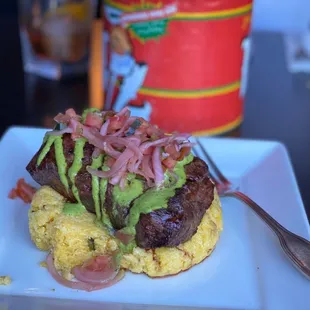 Flat iron steak for $30. Goat cheese polenta with chimichurri sauce and pickled onions and tomato garnish.