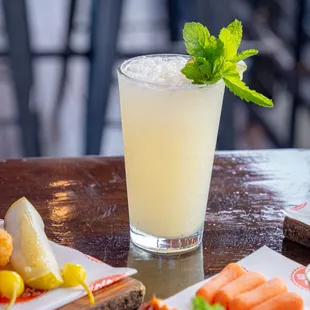 a glass of lemonade and a plate of food