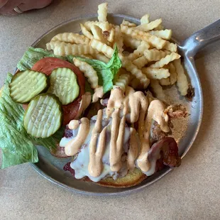 Bacon cheeseburger with fries.