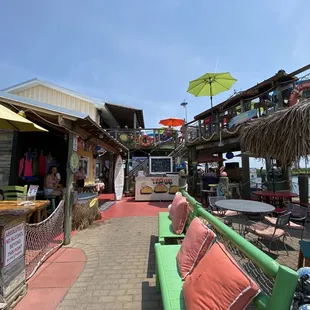 a green bench and umbrellas