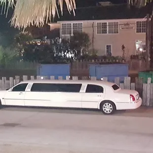 a white limousine parked on the side of the road