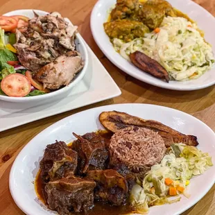 three plates of food on a wooden table