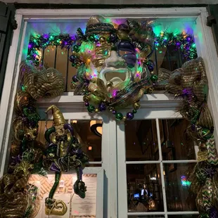a window decorated for mardi gras