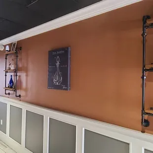 a wall with shelves and a wine rack
