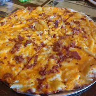 a pizza with cheese and bacon