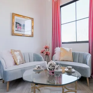 a living room with pink drapes