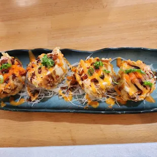 three sushi rolls on a blue plate