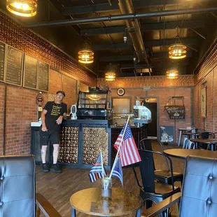 a man and a woman standing in a coffee shop